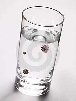 Glass of water infected from virus contagion risk. photo