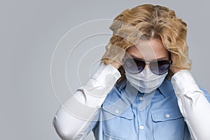 Virus Ideas. Concept of Coronavirus of Depressed Caucasian Woman In Glasses Touching Hair. Wearing Flu Virus Mask For Viral