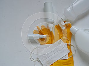 Virus protection equipment, medical gloves, medical protective mask and antiseptics spread out on a white background.Medical