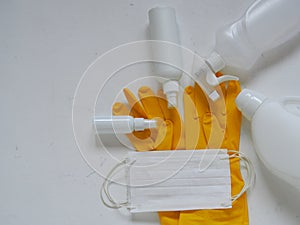 Virus protection equipment, medical gloves, medical protective mask and antiseptics spread out on a white background.Medical