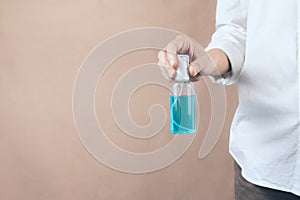 Virus protection  Person holding an alcohol spray.