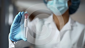 Virus researcher holding influenza antiviral drug test tube, epidemic infection