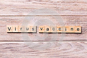 Virus vaccine word written on wood block. virus vaccine text on wooden table for your desing, coronavirus concept top view