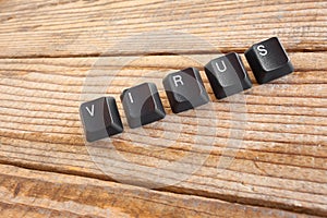 VIRUS wrote with keyboard keys on wooden background