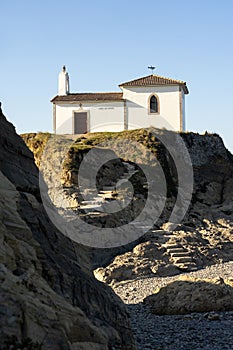 Virxe do Porto (Valdoviño) hermitage and cliffs in the Rias Altas touristic area of Galicia at sunset, Meiras, Spain