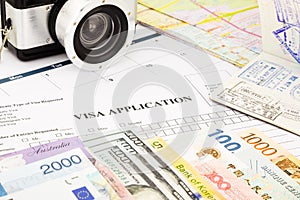 Visa application form, passport, world currency and banknotes