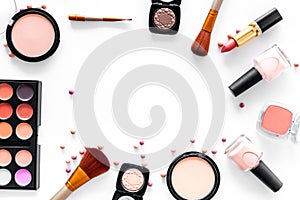 Visagiste work table with decorative cosmetics of beige and nude tones set white background top view mockup