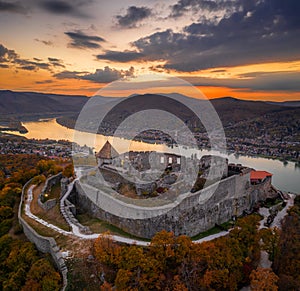 Visegrad, Hungary - Aerial panoramic drone view of the beautiful high castle of Visegrad with autumn foliage and trees