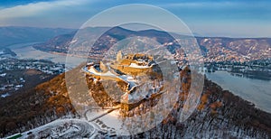 Visegrad, Hungary - Aerial panoramic view of the beautiful snowy high castle of Visegrad at sunrise on a winter morning