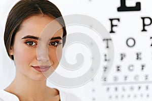 Vision. Beautiful Woman With Visual Eye Test Chart On Background