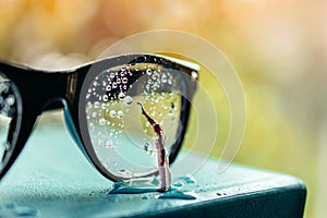 Vision Concept. Miniature Cleaner Wipe out Many Droplet on Eyeglasses
