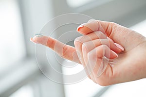 Vision Contact Lenses. Beautiful Woman Holds Finger on a Contact