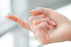 Vision Contact Lenses. Beautiful Woman Holds Finger on a Contact