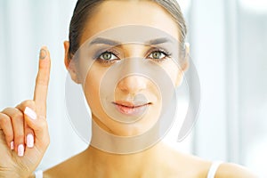 Vision Contact Lenses. Closeup With Beautiful Woman Face