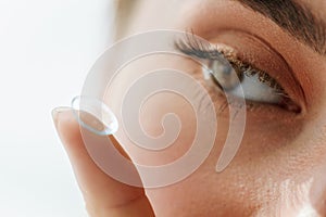 Vision Contact Lenses. Closeup With Beautiful Woman Face