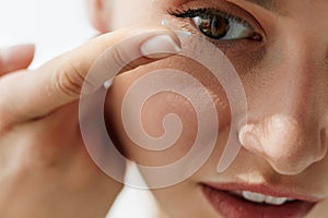 Vision Contact Lenses. Closeup With Beautiful Woman Face