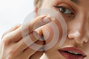 Vision Contact Lenses. Closeup With Beautiful Woman Face