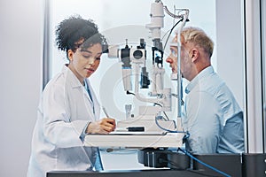 Vision, eye exam and writing with a doctor woman or optometrist testing the eyes of a man patient in a clinic. Hospital