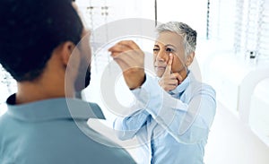 Vision, eyes and medical test with a man at the optometrist for prescription diagnosis or assessment. Distance, measure
