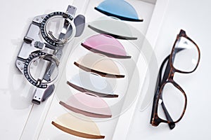 Vision glasses frame and Eye Test Frame near many colorful ophthalmological lenses for eye protection