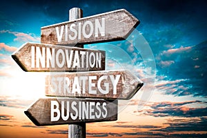 Vision, innovation, strategy, business - wooden signpost, roadsign with four arrows