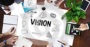 Vision text by icons and business people on table