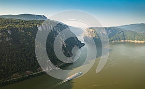 Visit beautiful Romania. Aerial view of a cruising ship traveling on Danube