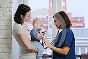 Visit of doctor pediatrician home, mother with baby son talking with doctor