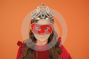 Visit public event anonymously. Winter new year party. Winter carnival. Incognito mode. Girl wear mask and crown orange