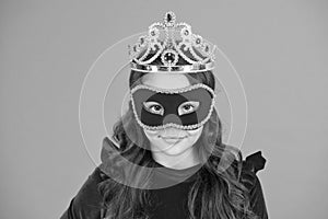 Visit public event anonymously. Winter new year party. Winter carnival. Incognito mode. Girl wear mask and crown orange