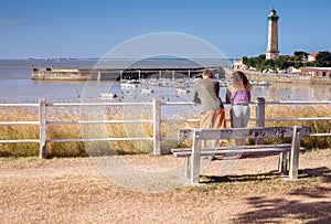 couple admiring the pretty landscape of Saint-Georges-de-Didonne and its famous lighthouse photo