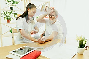 The visiting nurse taking care of senior man