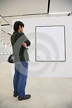 Visitor looks on frame in showroom photo