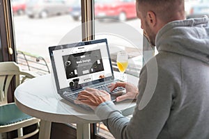 Visitor open a responsible website of the design company on his laptop photo