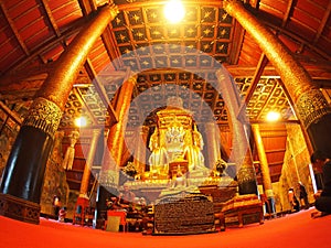 Visitor praying inside of the famous mural painting of the northern THAILAND WAT PHUMIN