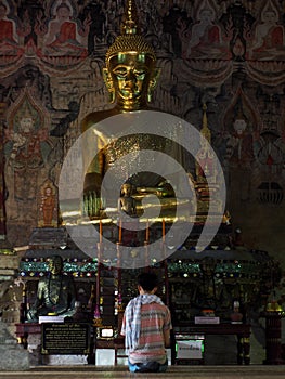 Visitor praying inside of a northern THAILAND temple