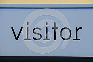 Visitor sign painted blue