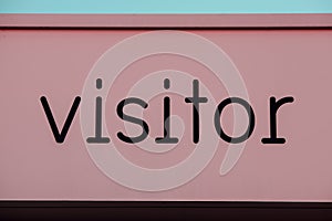 Visitor sign painted pink