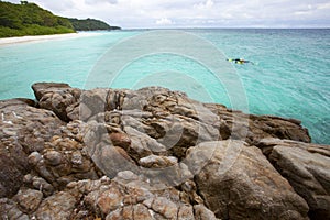 Visitor snorkeling in clear water of tachai island