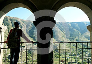 Visitor at the Two-arched Portico of Church of the Assumption at Vardzia Medieval Cave City on Erusheti Mountain, Georgia