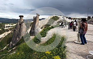 Visitors admire fairy chimneys near Urgup in the Cappadocia region of Turkey.