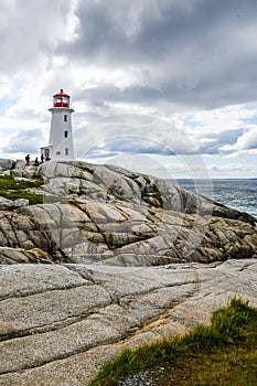 Visitors Climbing to Peggy's Cove Lighthouse