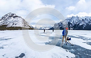 Visitors Enjoying Frozen Lake Minnewanka in Banff National Park