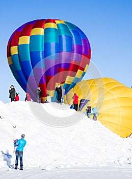 Visitors enjoying the sight of hot air balloons inflating and getting ready to take off