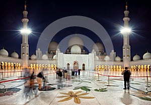 Visitors Entering Grand Mosque of Zayed in Abu Dhabi of Emirates at dusk