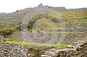 Visitors Exploring the Ancient Inca Ruins of Machu Picchu, UNESCO World Heritage Site in Cusco Region of Peru