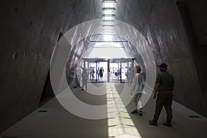 Visitors leaving the darkness of the Yad Vashem museum in Jerusalem Israel and moving into the bright light of day.