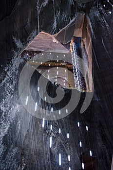 Visitors looking in the pit, salt mine Turda