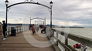 Visitors Strolling on White Rock Pier on April 7, 2024, BC, Canada