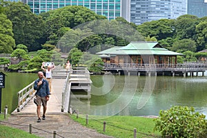 Visitors to the teahouse in the middle of Hamarikyu Park